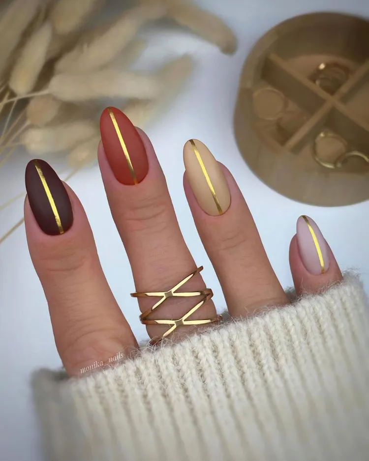 fall-gradient-nails-with-gold-strip- 2023 fall nail trends