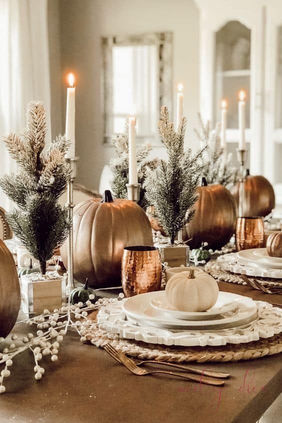 Gold pumpkins and mini Christmas trees thanksgiving tablescape 