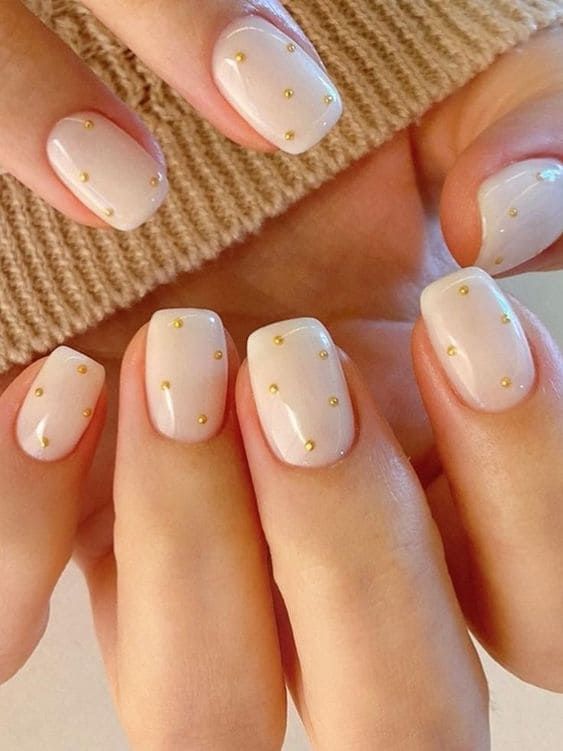 milky white gold dot new years nails